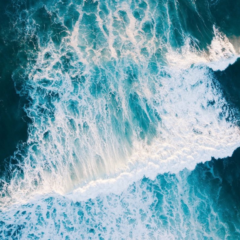 wavy body of water during daytime